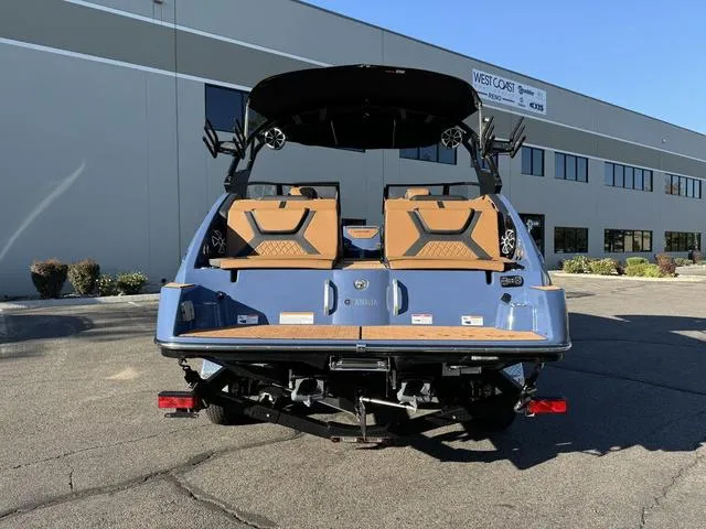 Slide: The Image of 2024 Yamaha Boats 222XD, blue exterior, parked outdoors near a commercial building. - 3
