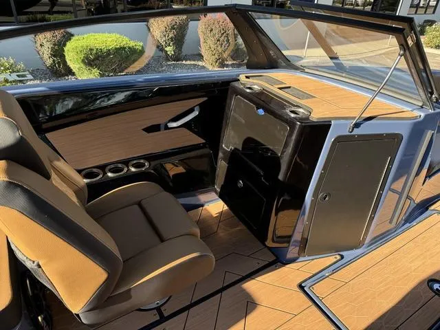 Slide: The Image of 2024 Yamaha Boats 222XD interior with tan seats and sleek dashboard design. - 5