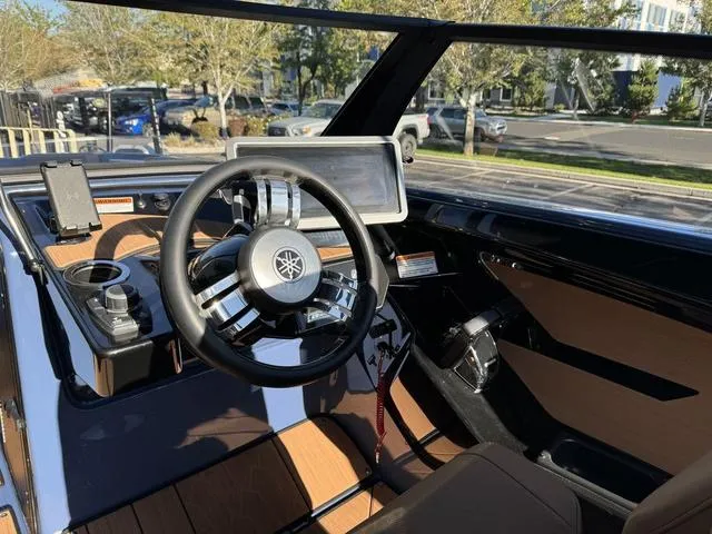 Slide: The Image of 2024 Yamaha Boats 222XD cockpit with modern steering wheel and dashboard controls. - 7