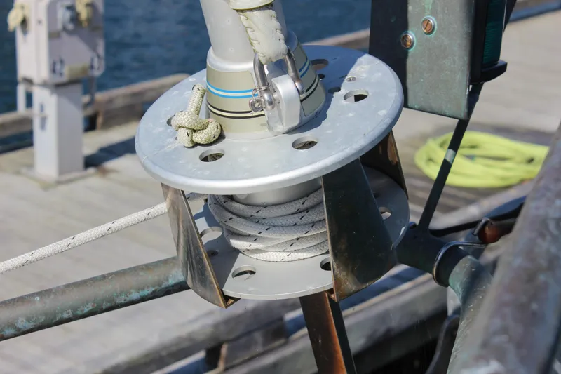 Slide: The Image of Close-up of a 2012 Custom Gartside Jespersen 40 sailboat's rigging mechanism at a dock. - 15