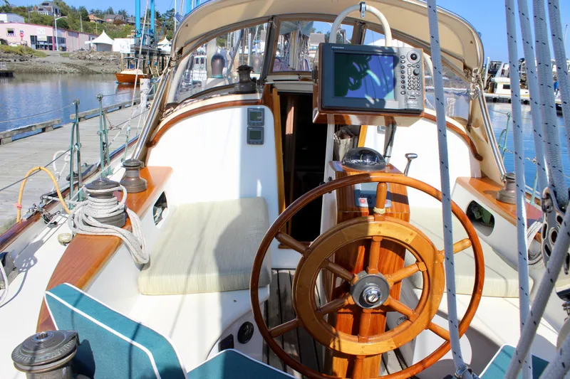 Slide: The Image of Cockpit of 2012 Custom Gartside Jespersen 40 sailboat with wooden wheel and navigation equipment. - 21