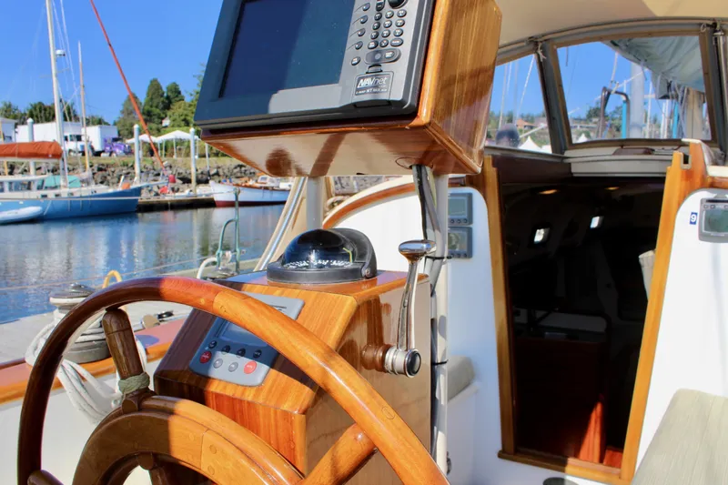 Slide: The Image of Cockpit of 2012 Custom Gartside Jespersen 40 sailboat with wooden steering wheel and navigation equipment. - 35