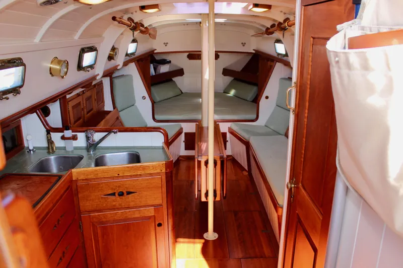 Slide: The Image of Interior of 2012 Custom Gartside Jespersen 40 sailboat with wooden finishes and cozy seating. - 38