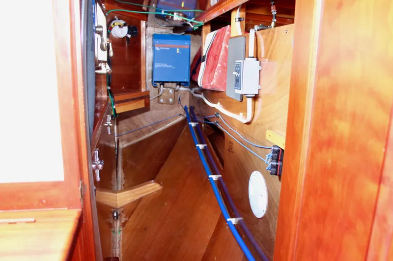 Slide: The Image of Interior of 2012 Custom Gartside Jespersen 40 sailboat, showcasing electrical and plumbing systems. - 49