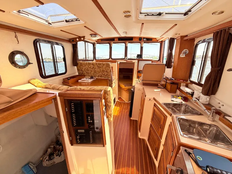 Slide: The Image of Interior of 2009 Ranger Tugs R-29 boat, featuring wood accents and spacious layout. - 10