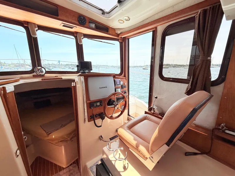 Slide: The Image of Interior of 2009 Ranger Tugs R-29 boat with helm, seating, and cabin view. - 13