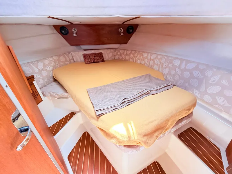 Slide: The Image of Cozy cabin interior of 2009 Ranger Tugs R-29 with a neatly made bed. - 15