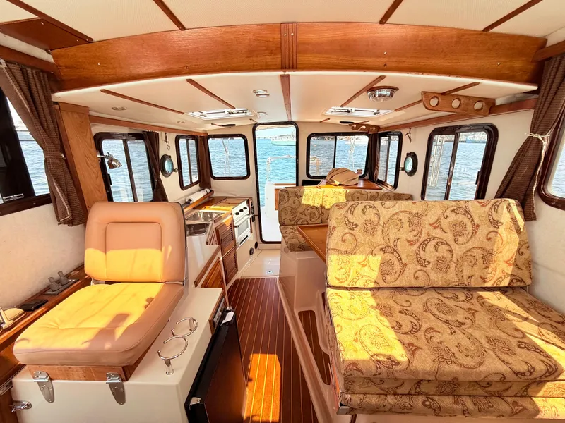 Slide: The Image of Interior of 2009 Ranger Tugs R-29 boat with wood accents and patterned seating. - 17