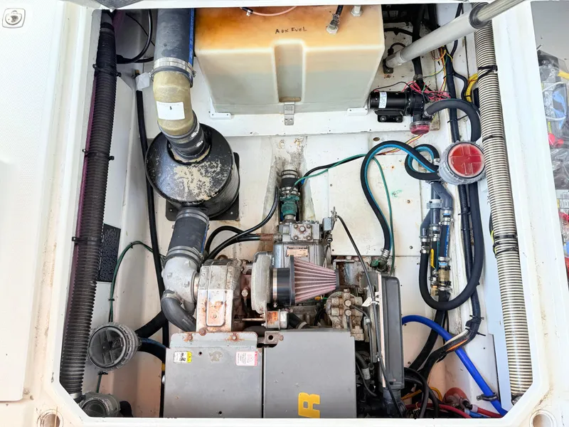 Slide: The Image of Engine compartment of a 2009 Ranger Tugs R-29, showcasing mechanical components and wiring. - 19