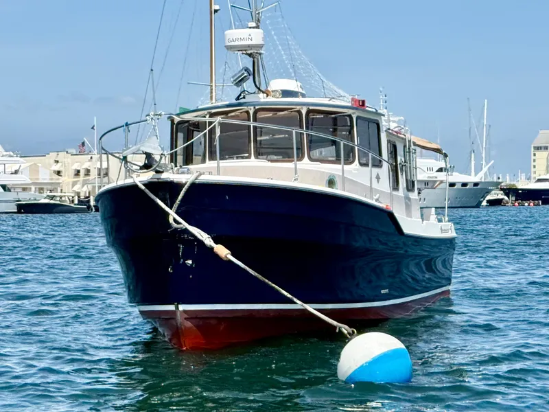 Slide: The Image of 2009 Ranger Tugs R-29 boat moored in a marina, clear blue sky background. - 4