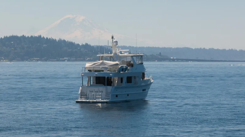 Slide: The Image of Outer Reef Yachts 720 Motoryacht 2022 cruising on a serene lake with mountain backdrop. - 13