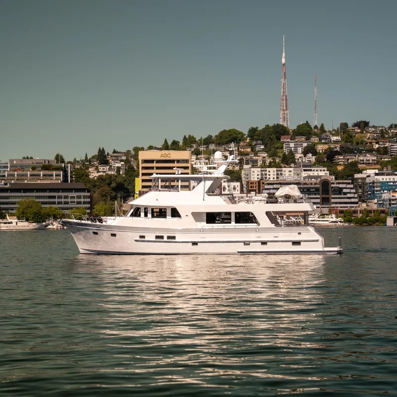 Slide: The Image of 2022 Outer Reef Yachts 720 Motoryacht on calm water with cityscape background. - 15