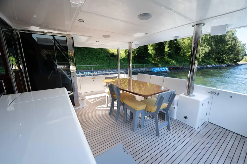 Slide: The Image of Spacious deck of 2022 Outer Reef Yachts 720 Motoryacht with dining area and scenic view. - 17
