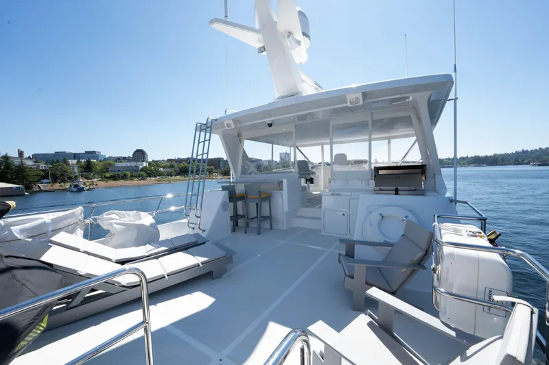 Slide: The Image of Luxurious 2022 Outer Reef Yachts 720 Motoryacht deck with seating and scenic water view. - 18
