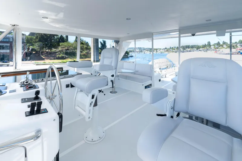 Slide: The Image of 2022 Outer Reef Yachts 720 Motoryacht helm with white seating and panoramic views. - 21