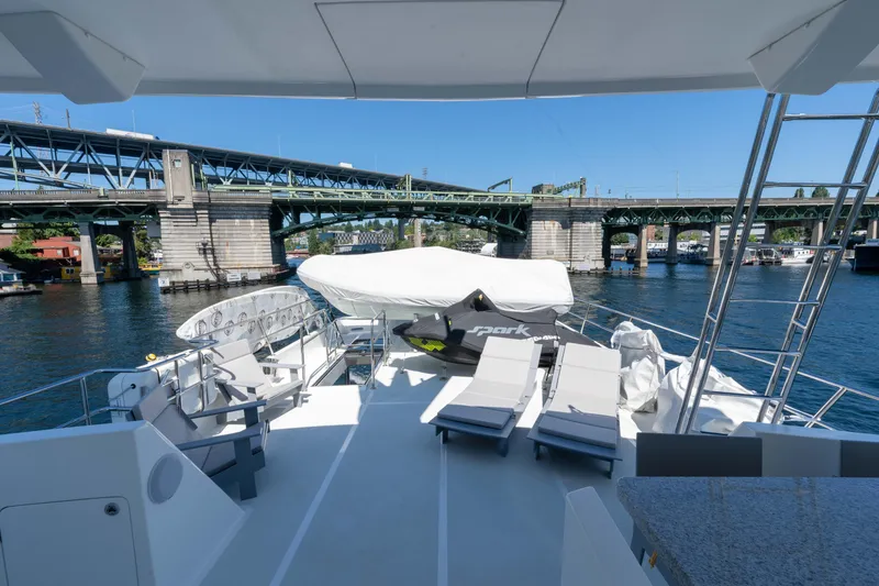 Slide: The Image of Outer Reef Yachts 720 Motoryacht 2022, spacious deck with lounge chairs, scenic bridge view. - 23
