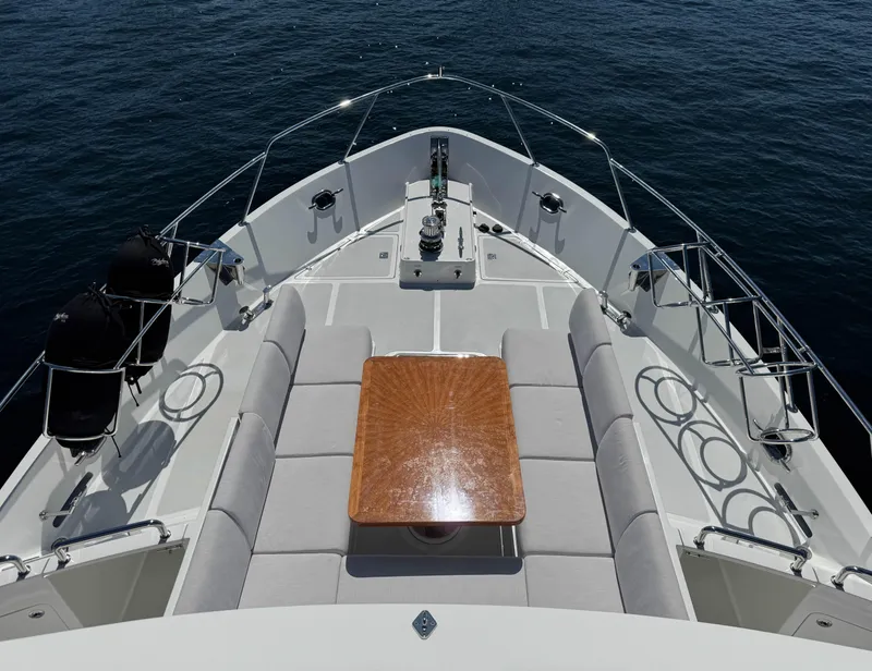 Slide: The Image of 2022 Outer Reef Yachts 720 Motoryacht bow with seating and table on calm water. - 25