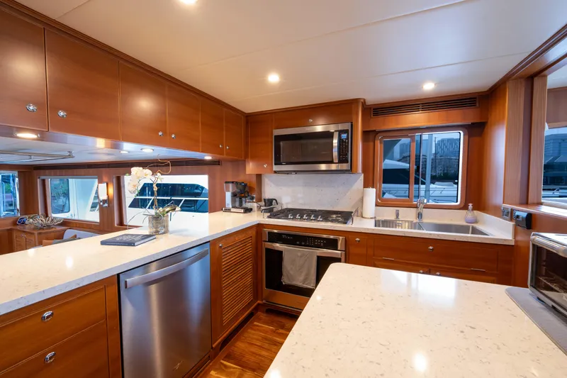 Slide: The Image of Luxurious kitchen in 2022 Outer Reef Yachts 720 Motoryacht with modern appliances and wood cabinetry. - 33