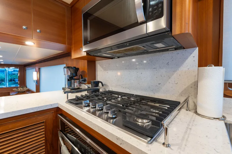 Slide: The Image of Modern kitchen in 2022 Outer Reef Yachts 720 Motoryacht with stove and microwave. - 36