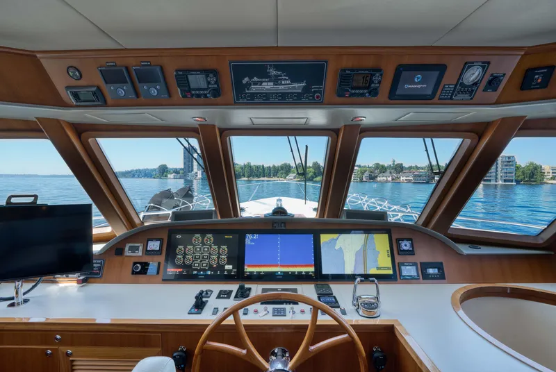 Slide: The Image of Cockpit view of 2022 Outer Reef Yachts 720 Motoryacht with navigation screens and steering wheel. - 40