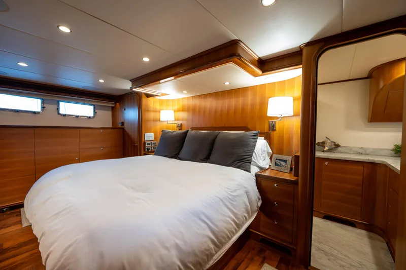 Slide: The Image of Luxurious bedroom in 2022 Outer Reef Yachts 720 Motoryacht with elegant wood paneling. - 45