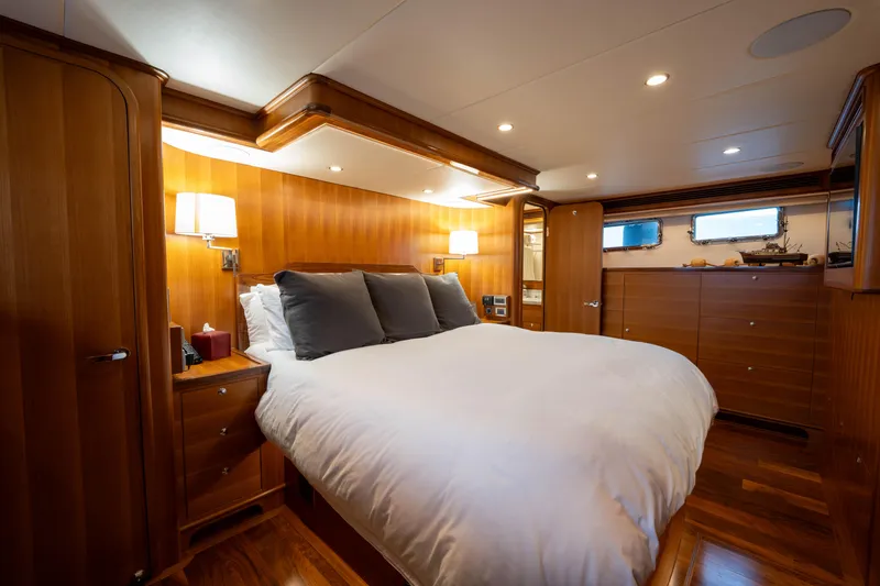 Slide: The Image of Luxurious bedroom in 2022 Outer Reef Yachts 720 Motoryacht with elegant wood paneling. - 46