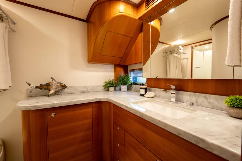 Slide: The Image of Luxurious bathroom in 2022 Outer Reef Yachts 720 Motoryacht with marble countertop and wooden cabinetry. - 47