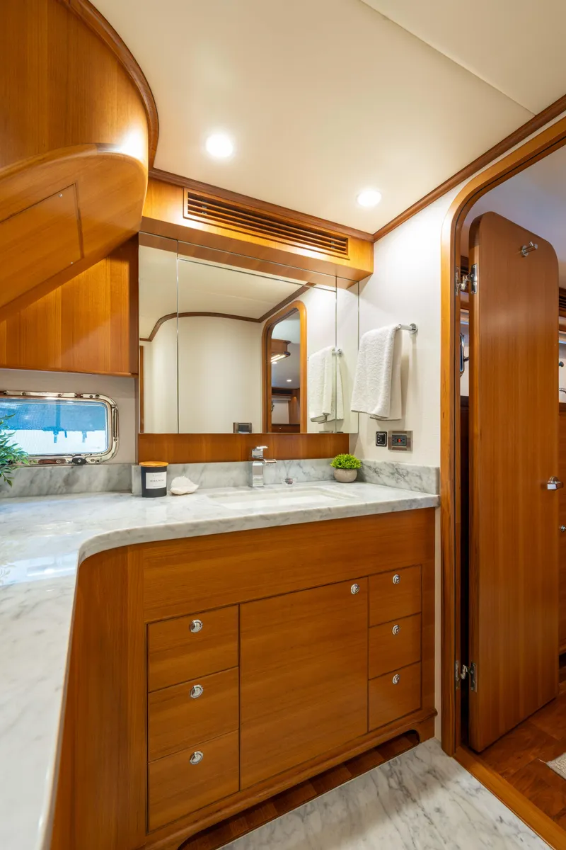 Slide: The Image of Luxurious bathroom in 2022 Outer Reef Yachts 720 Motoryacht with wood cabinetry and marble countertop. - 48