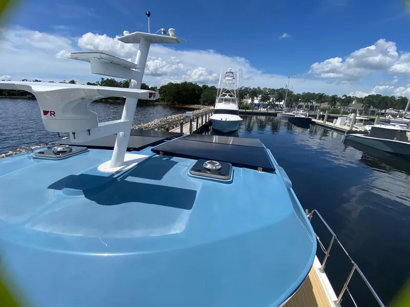 Slide: The Image of 2007 Manta 44 Power Cat docked at marina under clear blue sky. - 11