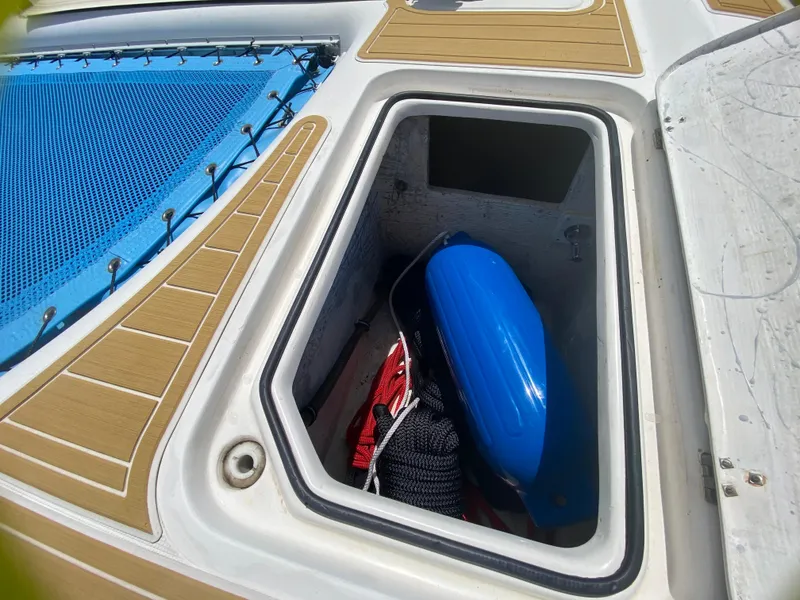 Slide: The Image of Storage compartment on 2007 Manta 44 Power Cat with blue fender and ropes. - 15