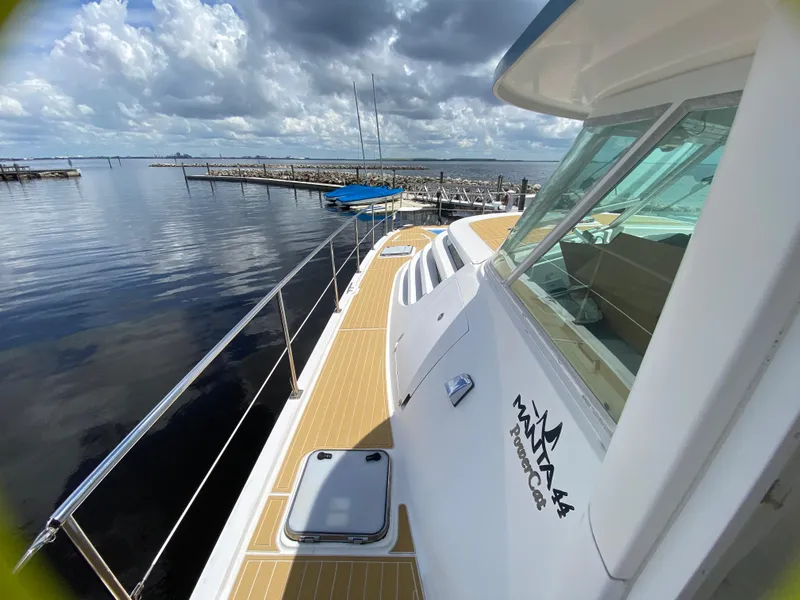 Slide: The Image of 2007 Manta 44 Power Cat on calm waters, docked under a cloudy sky. - 18