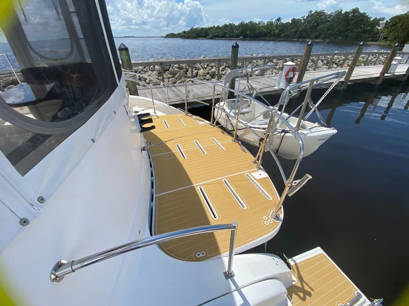 Slide: The Image of 2007 Manta 44 Power Cat docked, featuring spacious deck and scenic waterfront view. - 20