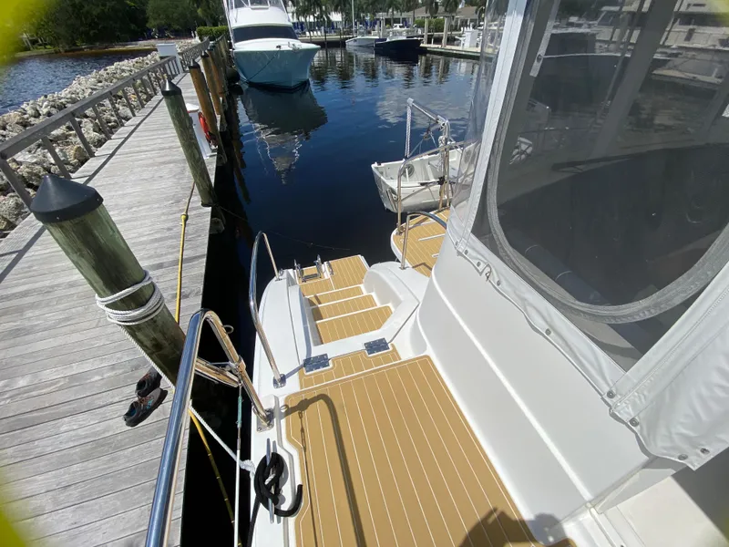 Slide: The Image of 2007 Manta 44 Power Cat docked, showing deck and marina view. - 22