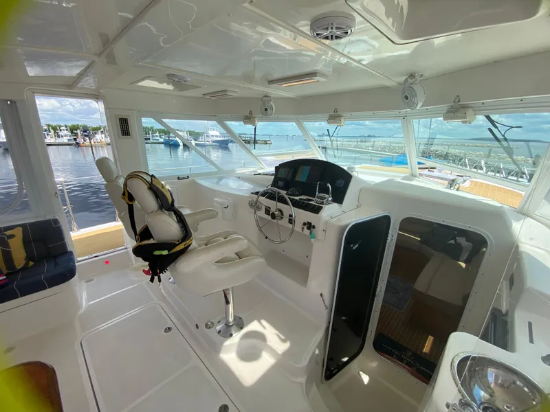 Slide: The Image of Interior of 2007 Manta 44 Power Cat, featuring helm station and panoramic windows. - 25