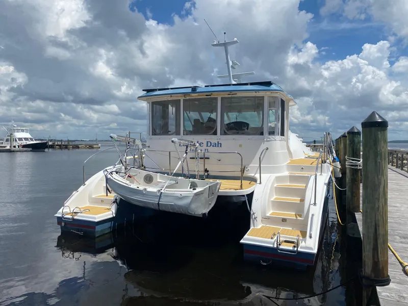Slide: The Image of 2007 Manta 44 Power Cat docked under cloudy skies. - 3