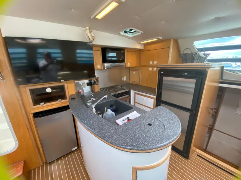 Slide: The Image of Interior of 2007 Manta 44 Power Cat kitchen with modern appliances and wood accents. - 37