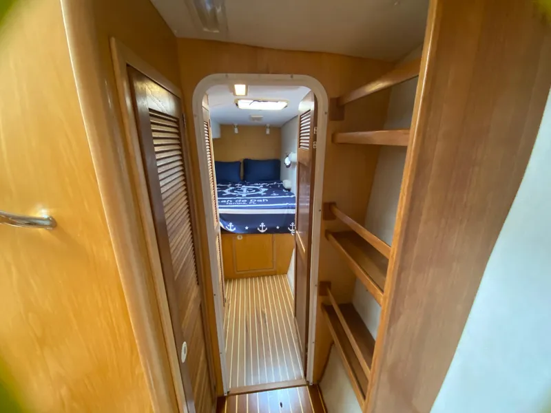 Slide: The Image of Interior of 2007 Manta 44 Power Cat with wooden shelves and cozy bedroom. - 43