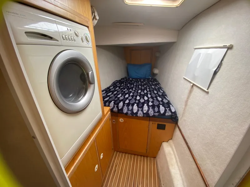 Slide: The Image of Cozy cabin with bed and washer in 2007 Manta 44 Power Cat. - 44