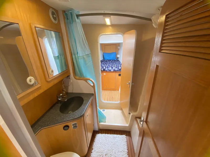 Slide: The Image of 2007 Manta 44 Power Cat bathroom with sink, mirror, and view into cabin. - 46