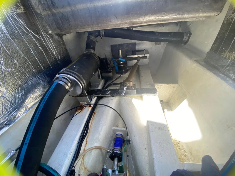 Slide: The Image of Engine compartment of 2007 Manta 44 Power Cat with visible hoses and components. - 48