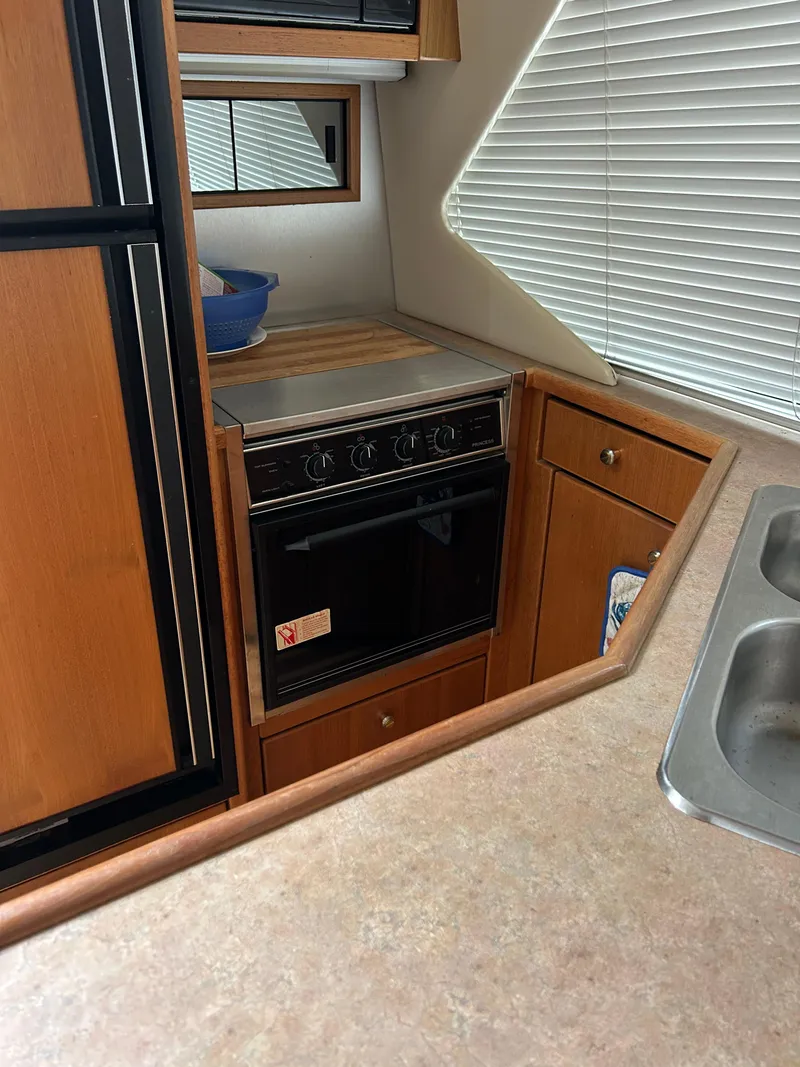 Slide: The Image of 2000 Bayliner 4087 Motoryacht kitchen with stove, cabinets, and sink. - 15