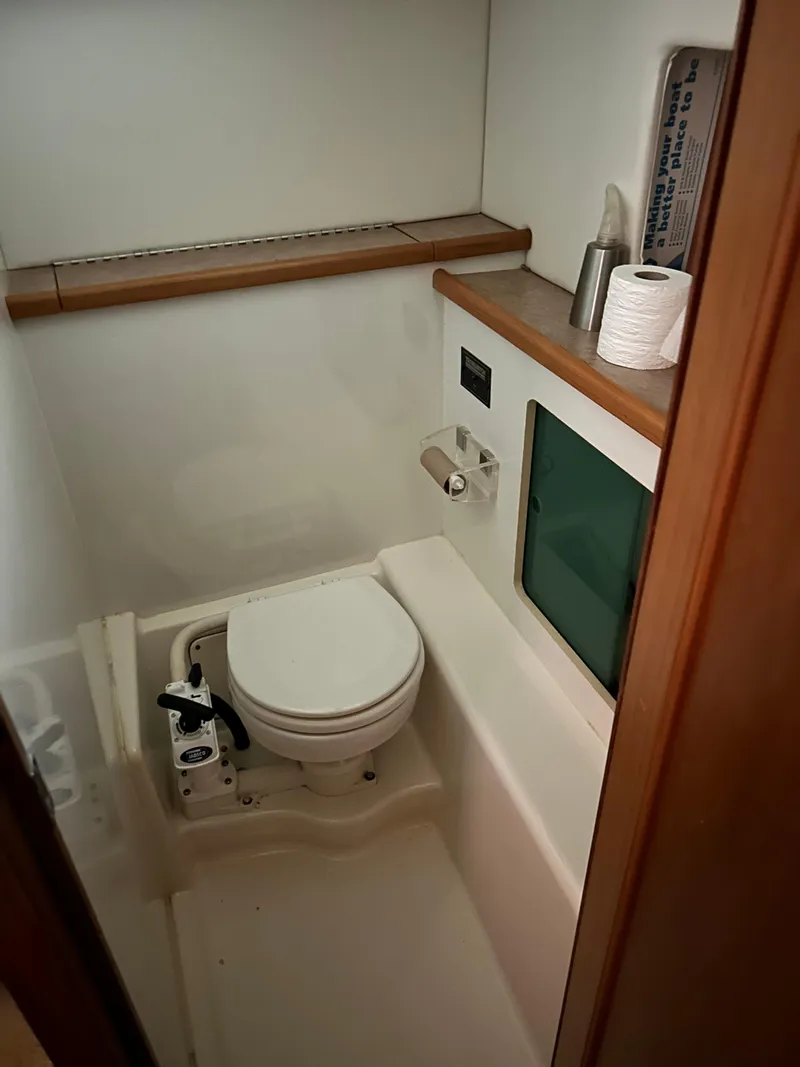 Slide: The Image of Bathroom in 2000 Bayliner 4087 Motoryacht with toilet and wooden accents. - 17