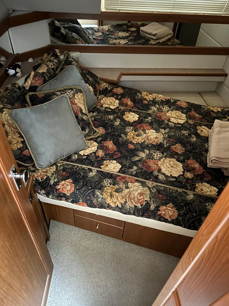 Slide: The Image of Cozy bedroom in 2000 Bayliner 4087 Motoryacht with floral bedding and wood accents. - 19