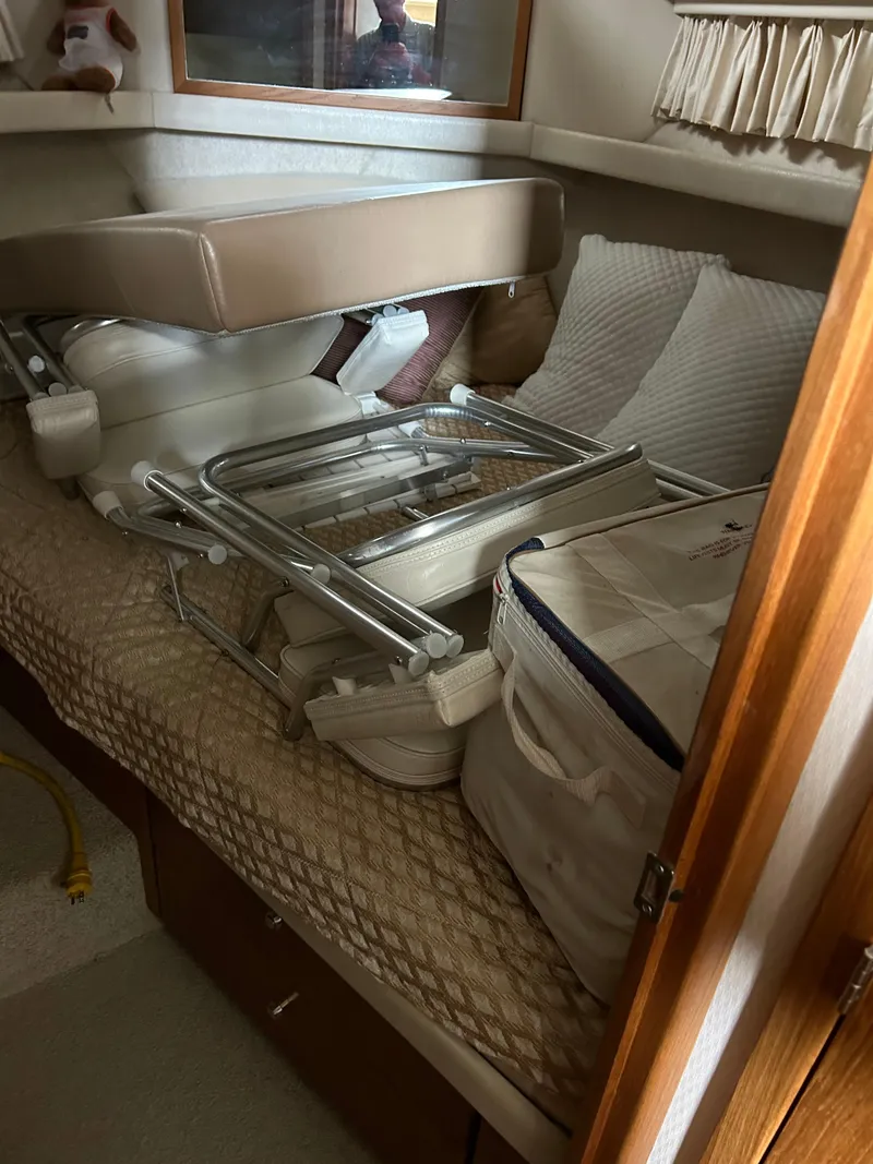 Slide: The Image of Interior cabin of 2000 Bayliner 4087 Motoryacht with stored items on bed. - 20