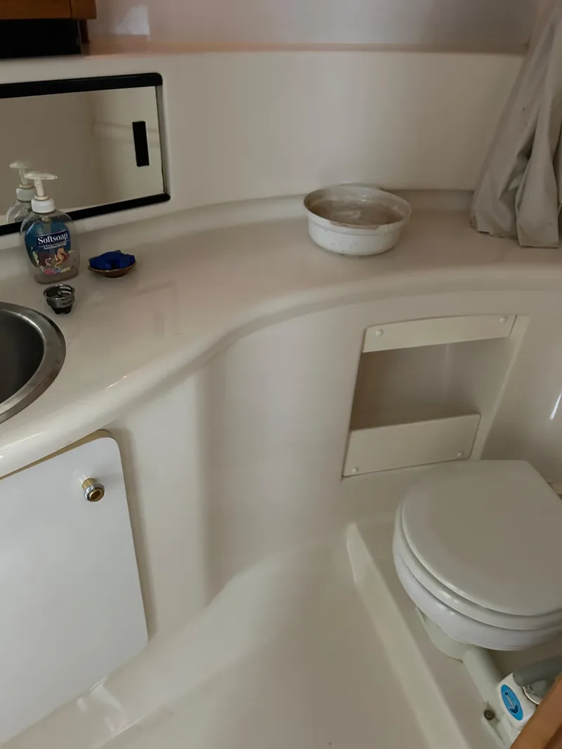 Slide: The Image of 2000 Bayliner 4087 Motoryacht bathroom with sink, mirror, and toilet. - 21