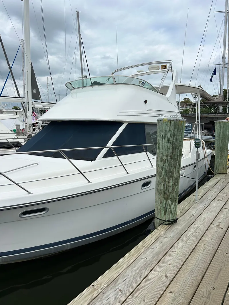 Slide: The Image of 2000 Bayliner 4087 Motoryacht docked at marina under cloudy skies. - 3