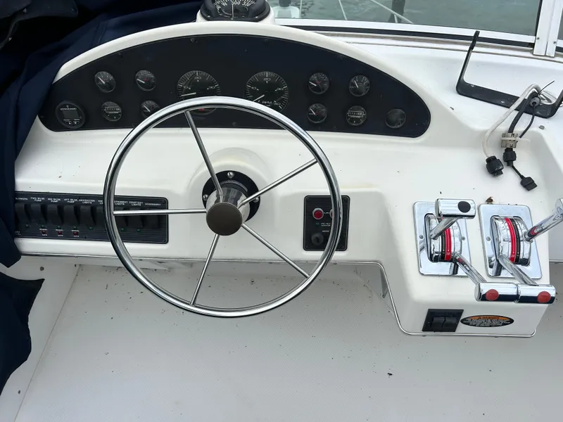 Slide: The Image of Bayliner 4087 Motoryacht 2000 helm with steering wheel and control panel. - 5