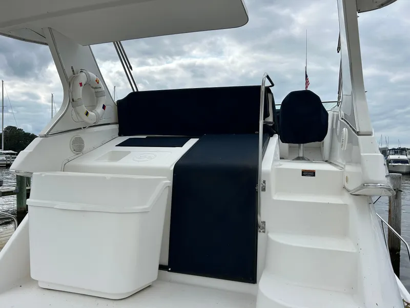 Slide: The Image of 2000 Bayliner 4087 Motoryacht deck with seating and storage, docked at marina. - 6