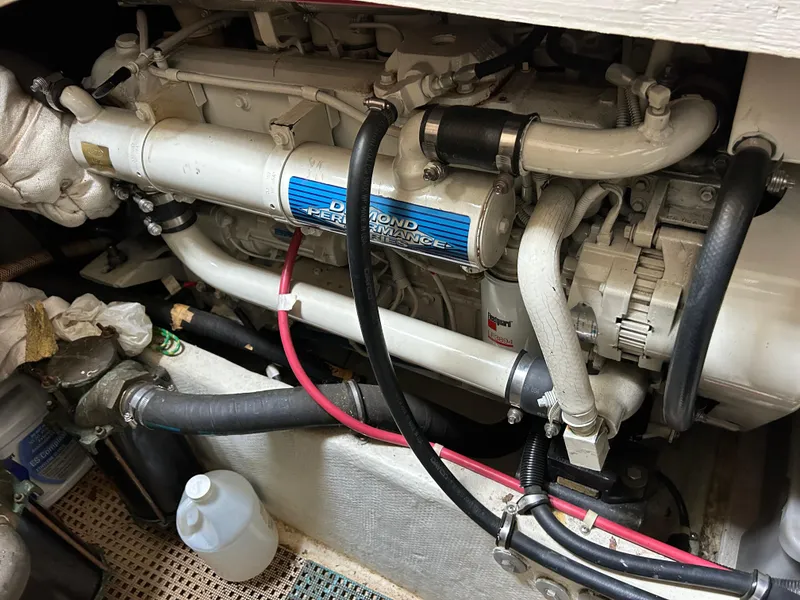 Slide: The Image of Engine compartment of 2000 Bayliner 4087 Motoryacht with visible hoses and components. - 7