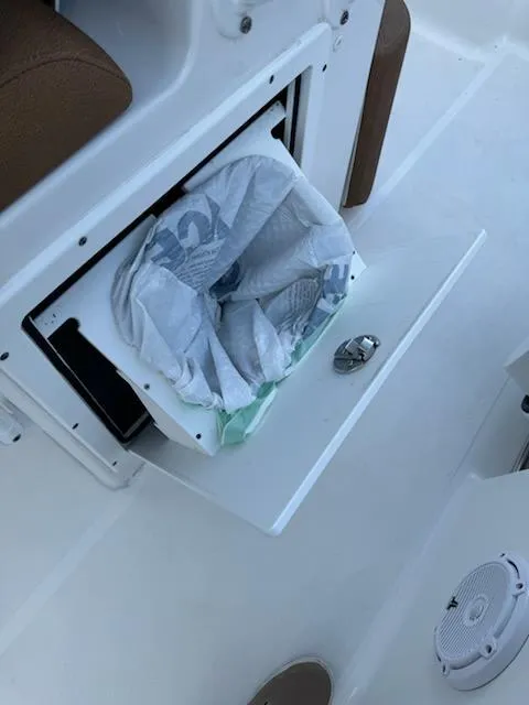 Slide: The Image of 2022 Sea Hunt Ultra 265 SE boat with built-in trash compartment and speaker. - 11